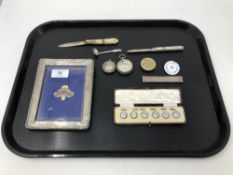 A tray of silver photo frame, two silver fob watch cases, two silver-bladed knives,