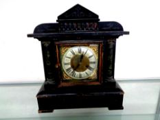 A late Victorian stained wooden mantel clock with brass and silver dial