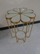 A contemporary metal mirrored topped occasional table in the form of a flower