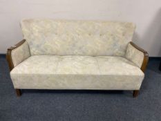 A Continental three seater settee in buttoned upholstery