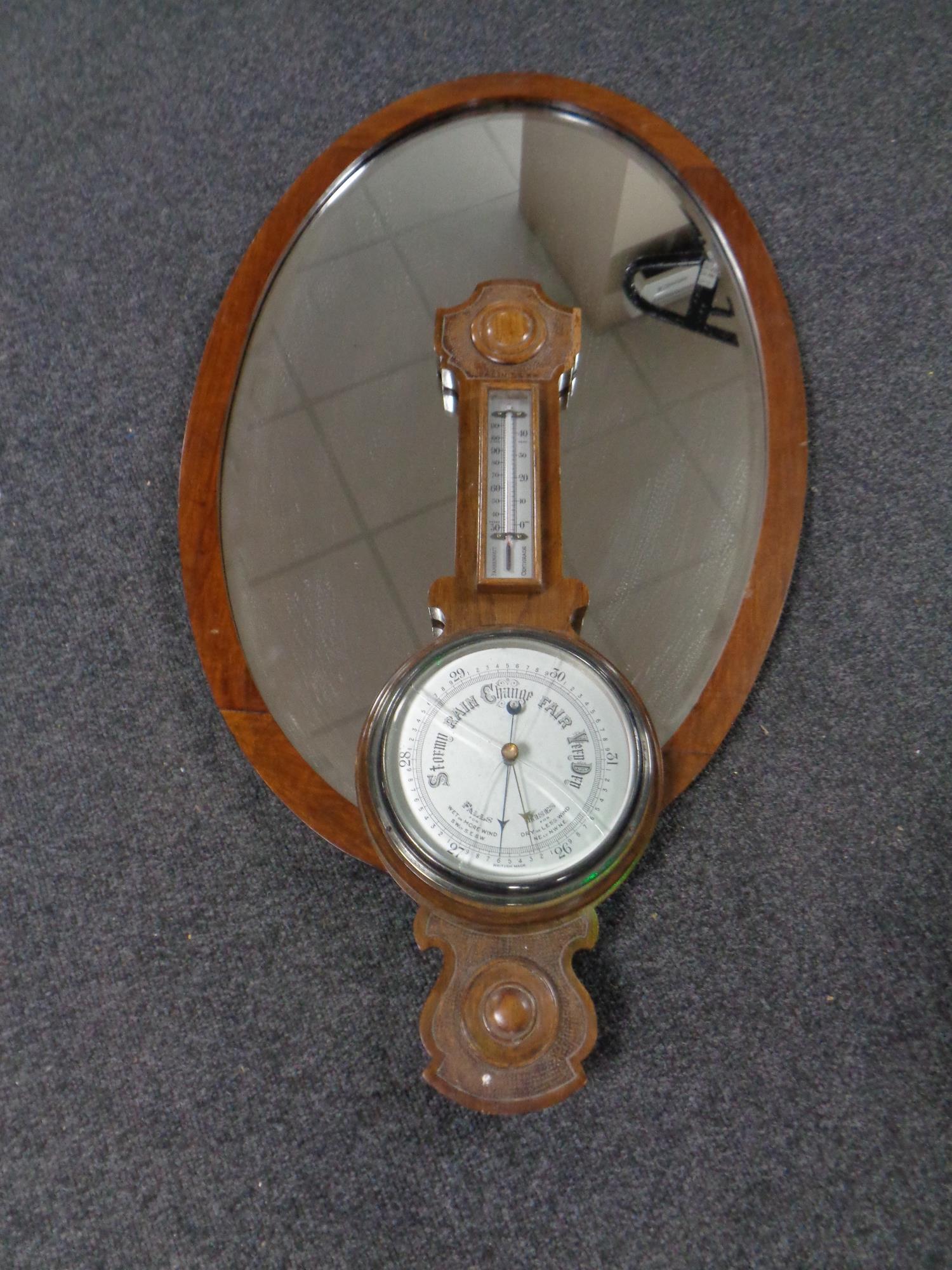 An Edwardian dressing table mirror together with an Edwardian oak barometer