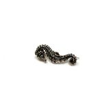 A silver seahorse brooch