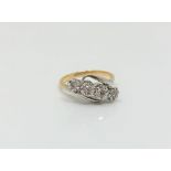 An 18ct gold and platinum four stone diamond ring,