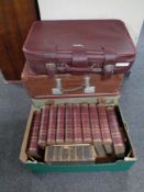 A box containing Chambers encyclopedias together with three vintage luggage cases