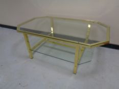 An octagonal brass glass topped coffee table with under shelf