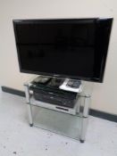 A Samsung UE32D5520 32'' LCD TV on stand together with Panasonic Blu Ray player Akai VCR and a