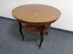 A 20th century continental mahogany two tier circular occasional table
