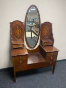 A late Victorian inlaid mahogany sunk centre dressing table with mirror back