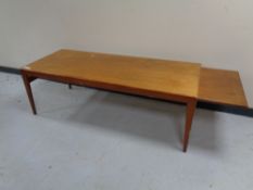 A mid 20th century teak extending coffee table