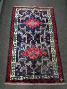 A Baluchi rug 140cm by 81cm