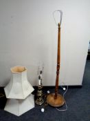 A beech standard lamp and two brass table lamps with shades