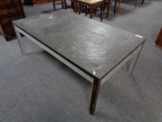 A 20th century continental slate topped coffee table on metal legs