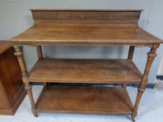 An Edwardian oak three tier serving table