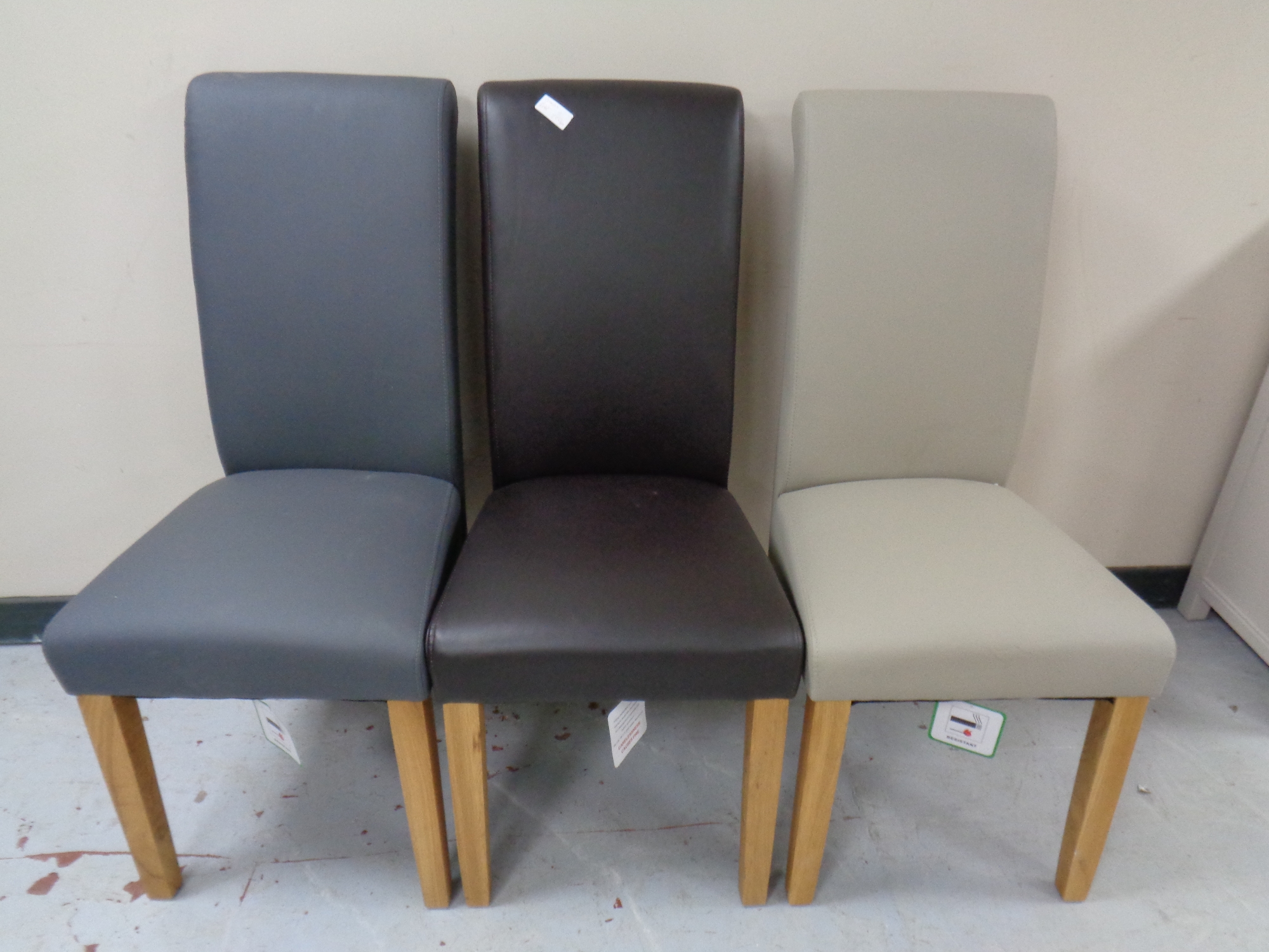 Three contemporary high back leather dining chairs
