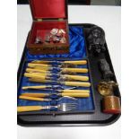 A tray containing cased fish cutlery, coal figures, brass figure of an eagle, pocket knife,