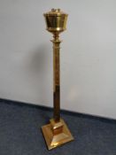 An antique brass rise and fall oil standard lamp