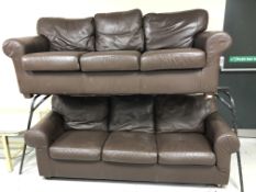 A pair of brown leather three seater settees