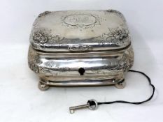 A 19th century German silver tea caddy, coat of arms to lid, on ball feet, original silver key.