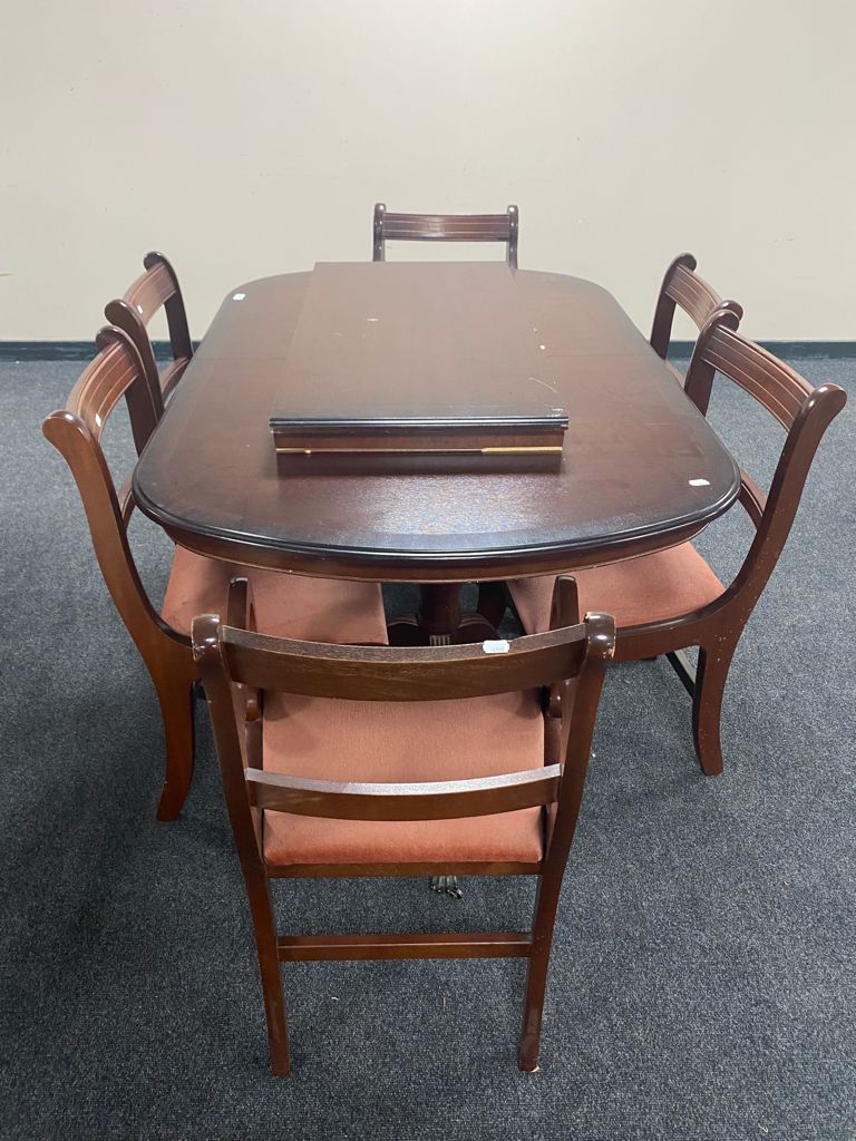 A reproduction extending dining table together with a set of six chairs