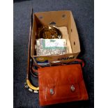 A box containing leather satchel, damask napkins, patchwork pillow cases,