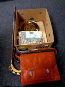 A box containing leather satchel, damask napkins, patchwork pillow cases,