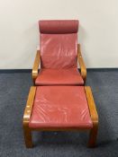 An Ikea relaxer armchair and stool upholstered in a red leather