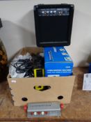 A box containing miscellany to include a biding machine, an Acoustic Solutions guitar mini amp,