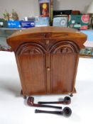 An Edwardian smoker's cabinet with pipes
