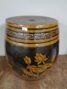 A glazed pottery barrel stool