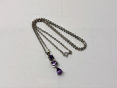 A 9ct white gold and amethyst necklace