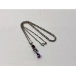 A 9ct white gold and amethyst necklace