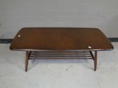 An Ercol solid elm and beech coffee table with under shelf in an antique finish
