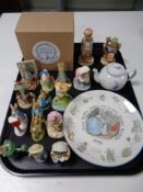 A tray containing two Hummel figures together with a quantity of Enesco Peter Rabbit figures,