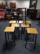 A set of eight 20th century plywood topped science lab stools on metal legs