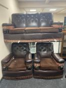 A three piece 1930s lounge suite upholstered in a brown button vinyl