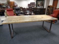 A reclaimed pine topped dining table on metal legs