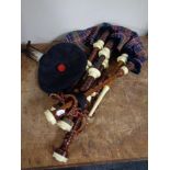 A set of Scottish bagpipes with tam o' shanter and plume