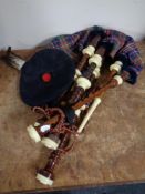 A set of Scottish bagpipes with tam o' shanter and plume