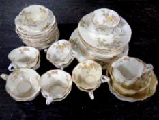 An antique floral patterned bone china tea service