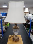 A brass and cut glass table lamp with shade