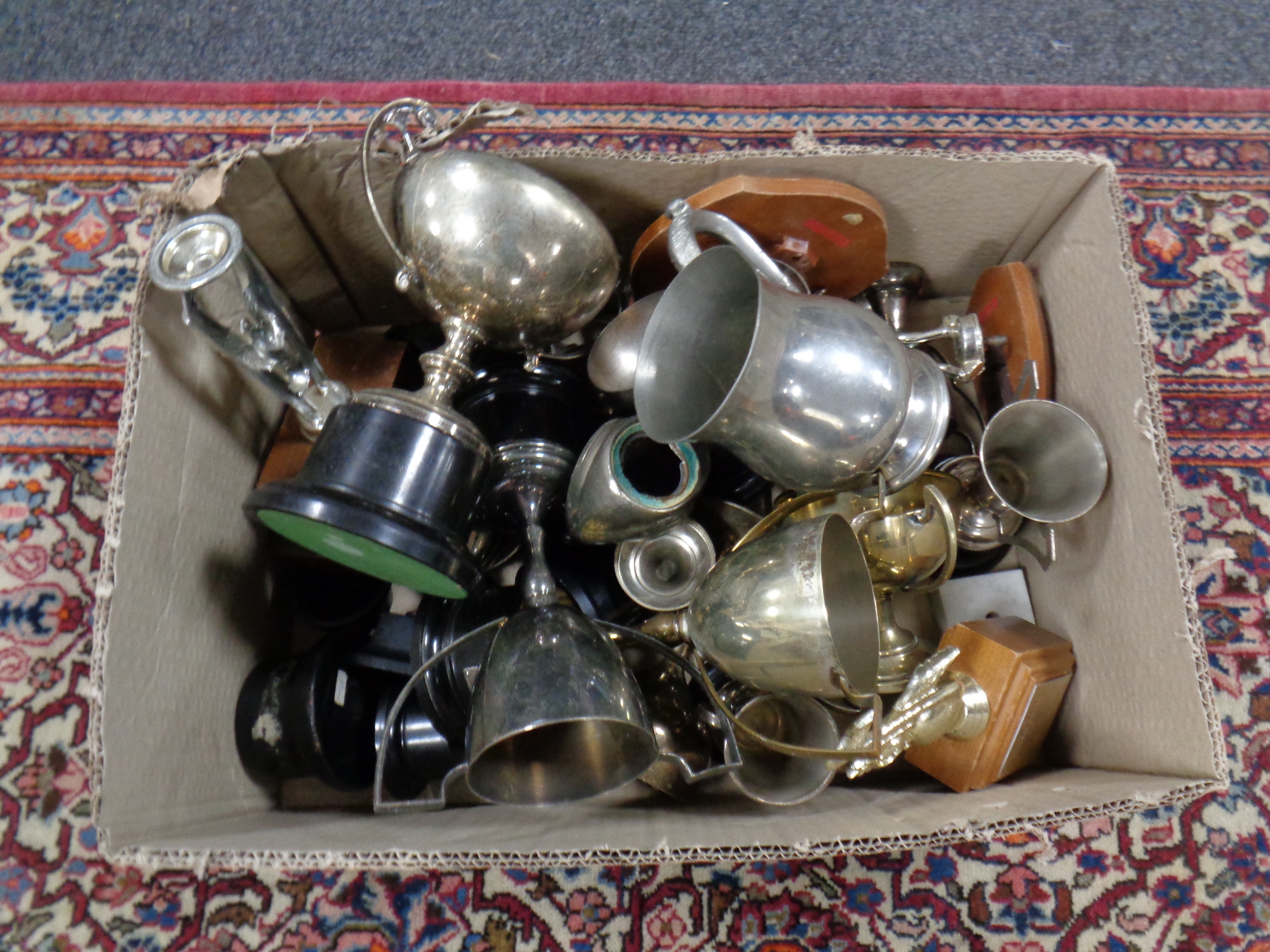 A box containing a quantity of plated trophies