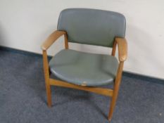 A mid 20th century teak armchair upholstered in a vinyl