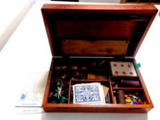 An Edwardian mahogany games box containing drafts, counters, cards,