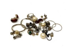 Twelve pairs of silver earrings