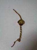 A 9ct gold lady's wristwatch on gilt strap