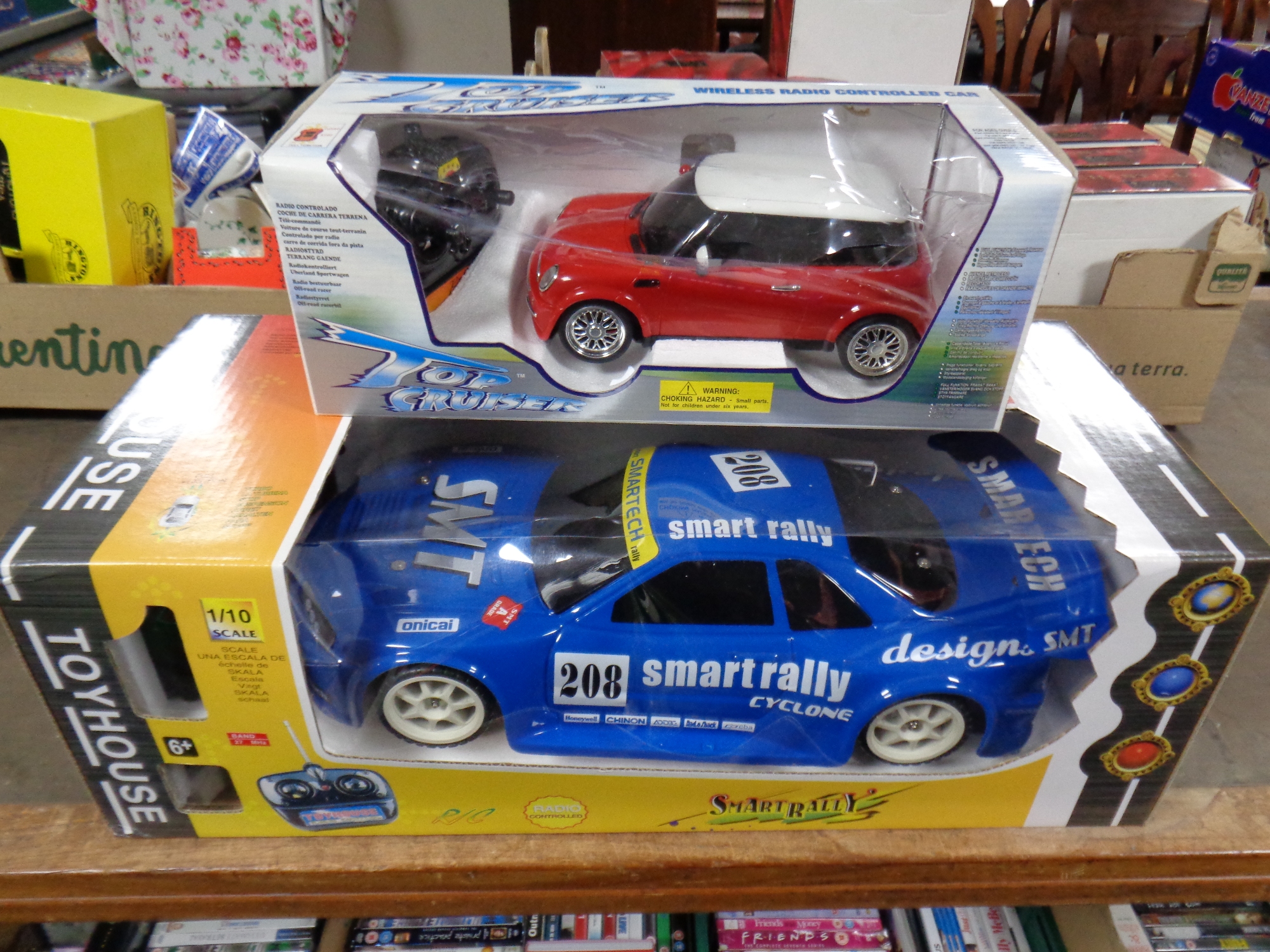 A remote controlled Smart Rally 1/10 vehicle together with a further remote controlled mini