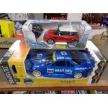 A remote controlled Smart Rally 1/10 vehicle together with a further remote controlled mini