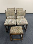 A set of four oak dining chairs upholstered in a tapestry fabric together with similar footstool