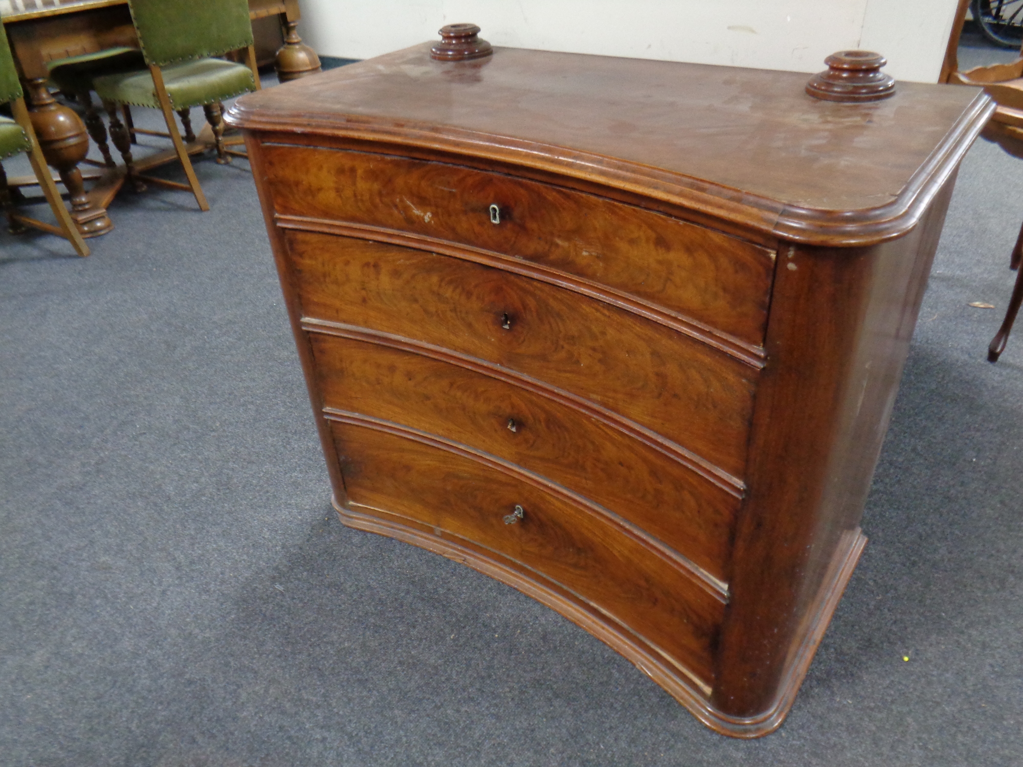 A 19th century concave four drawer chest