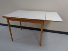 A mid 20th century melamine topped extending kitchen table